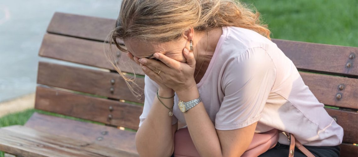 Mother on a bench crying